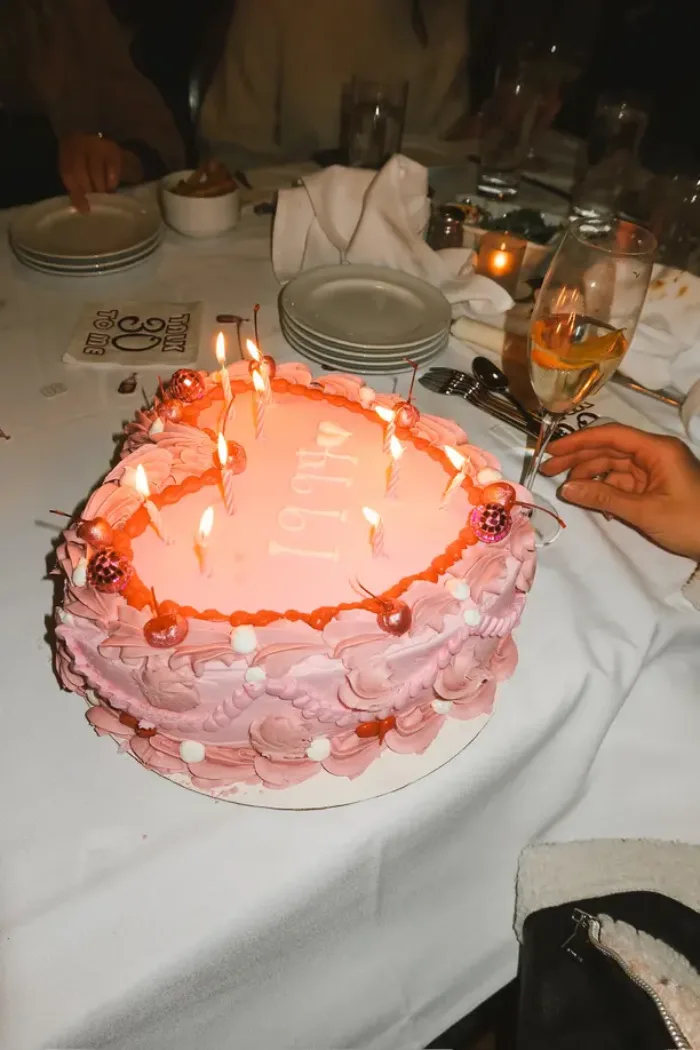 21st birthday themes for her with a pink heart cake and lit candles
