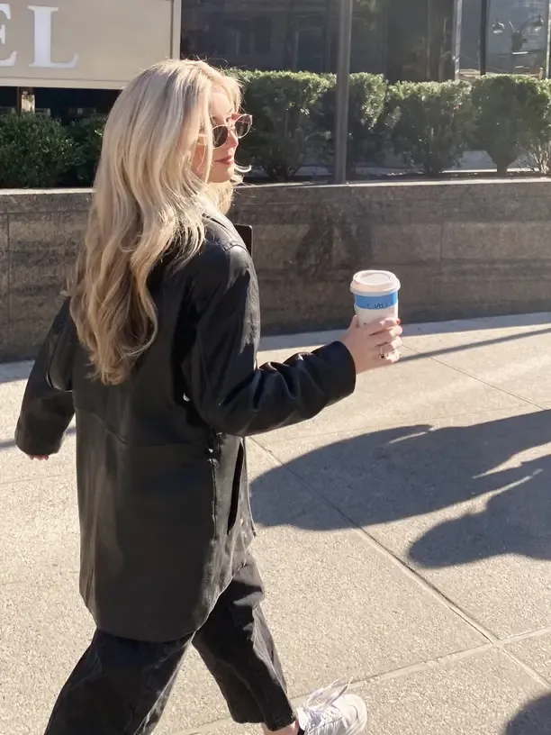 edgy outfit with a black leather jacket on a city street