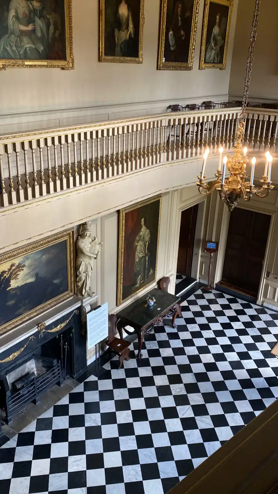 foyer with checkered floor and chandelier