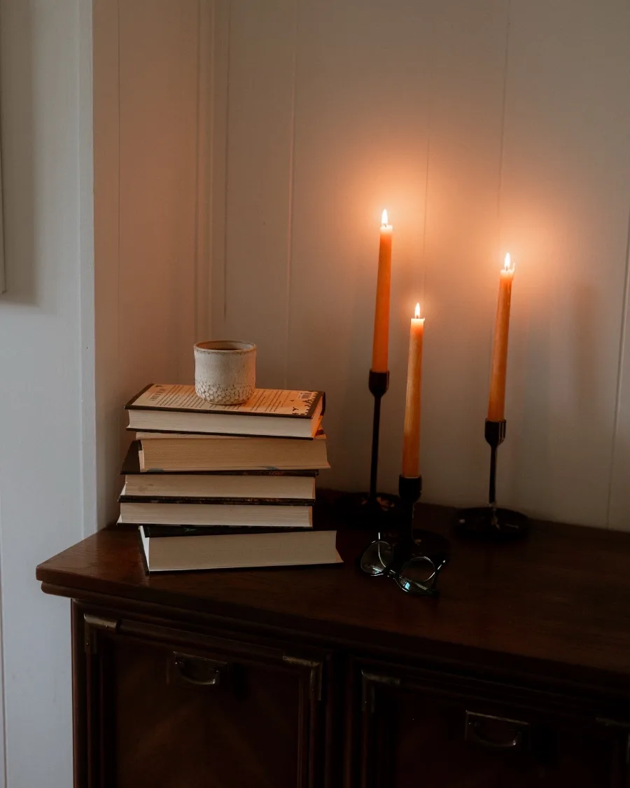 taper candles on a stack of books