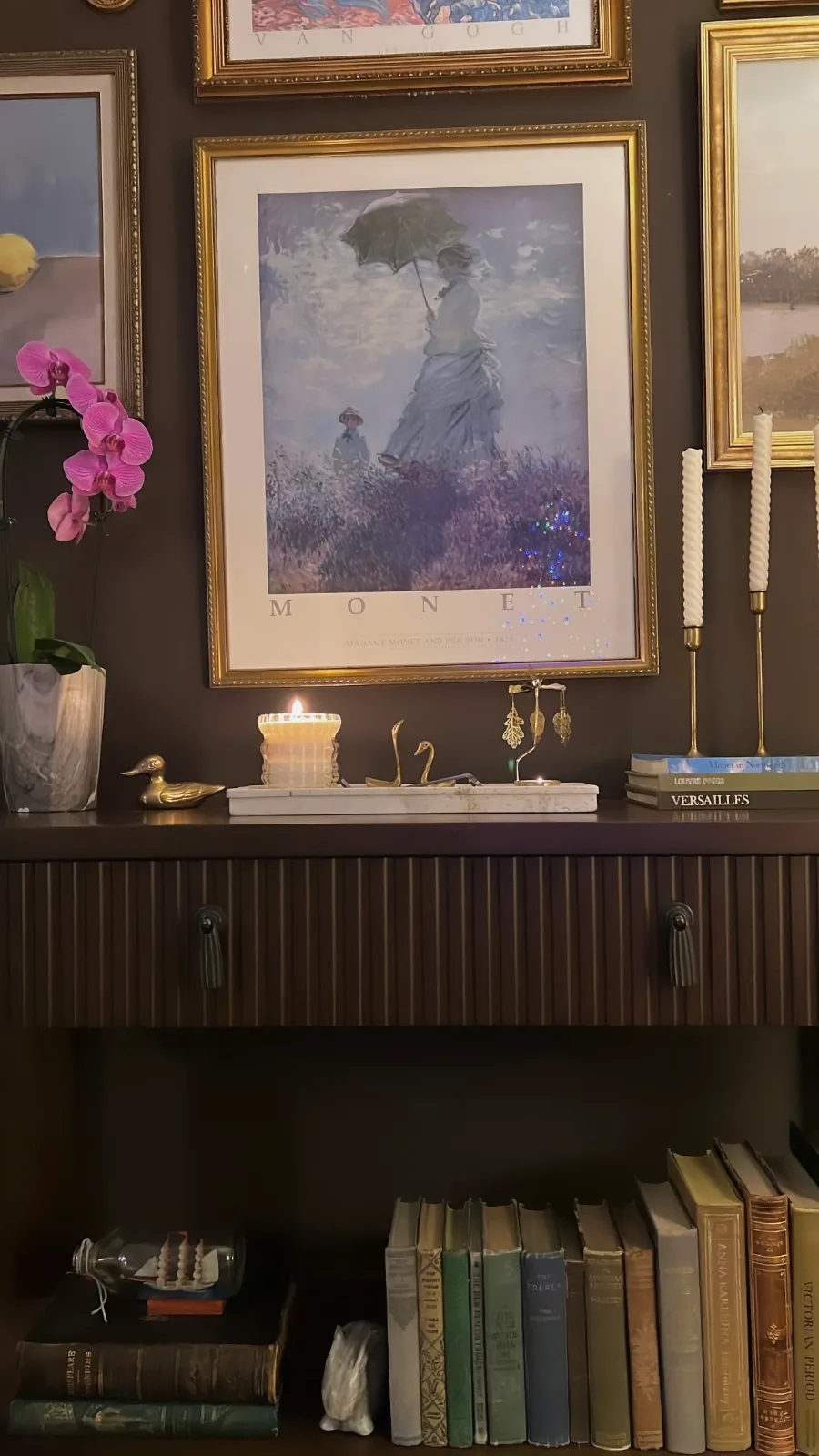 console table styled with art and orchids
