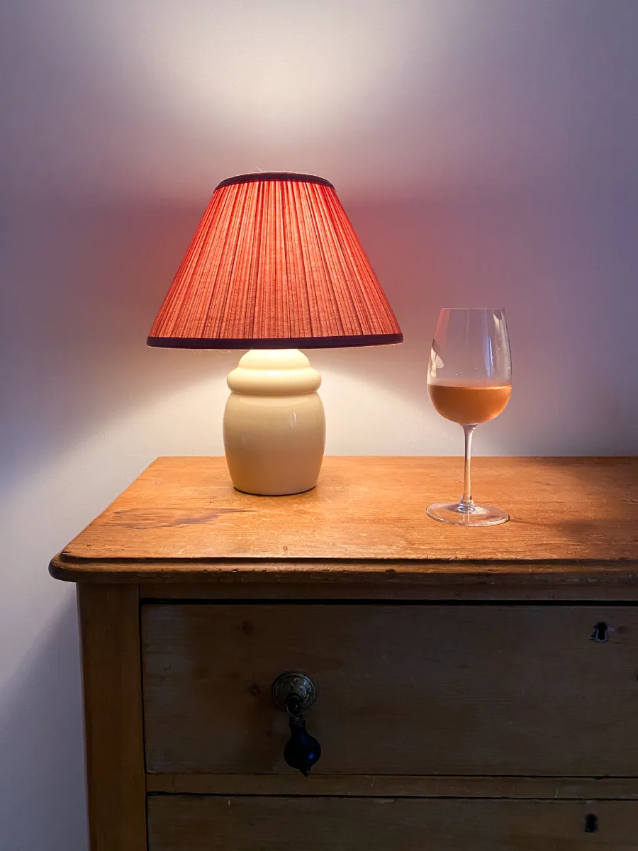 pleated table lamp on a wood dresser