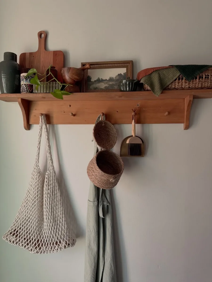 wooden peg rail with bags and hats