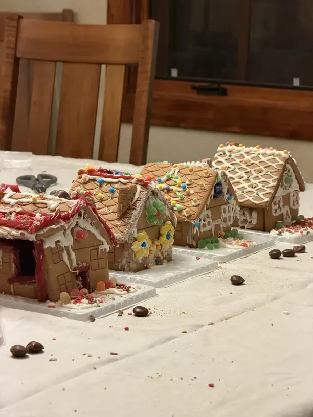 Gingerbread house decorating ideas with a row of candy covered gingerbread houses on a table.