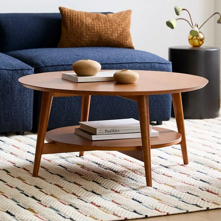 Oval wood mid century coffee table on a striped rug