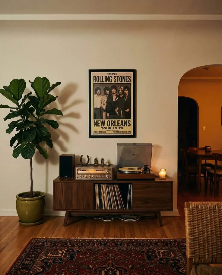 Low wood record console with a turntable and fiddle leaf fig