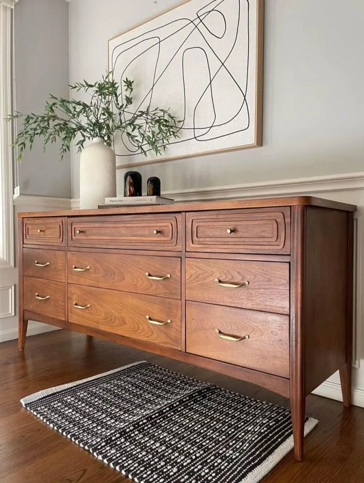 Long walnut mid century dresser under abstract art