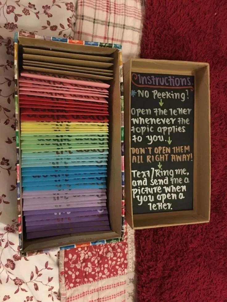 Wooden box of rainbow open when letter envelopes with a chalkboard note