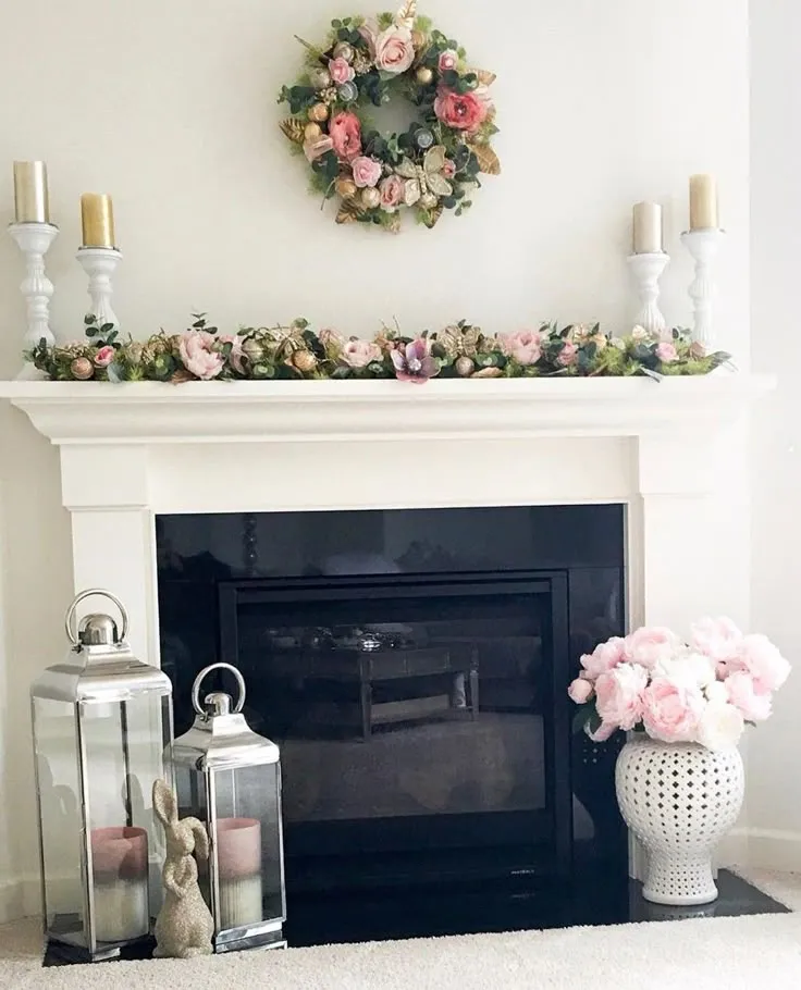 Spring decor ideas with a white fireplace mantel, flowers and a spring wreath