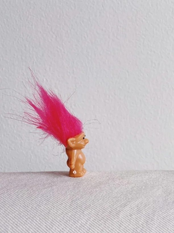 Troll gifts for Christmas with a classic troll doll with bright pink hair.