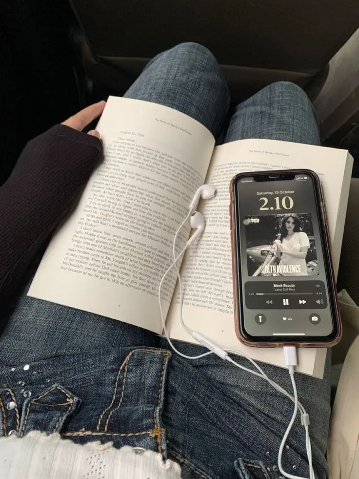 Valentines playlist with a phone playing music on an open book