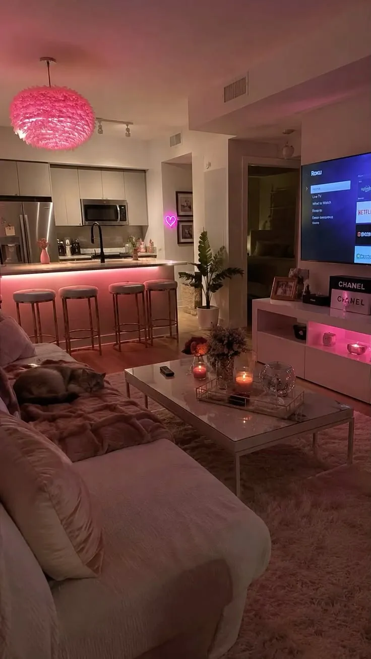 Vibey apartment living room with pink LED lighting, a cozy sofa and plants
